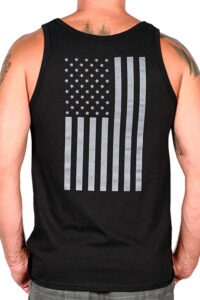 Man wearing black tank top with white American flag print on the back.