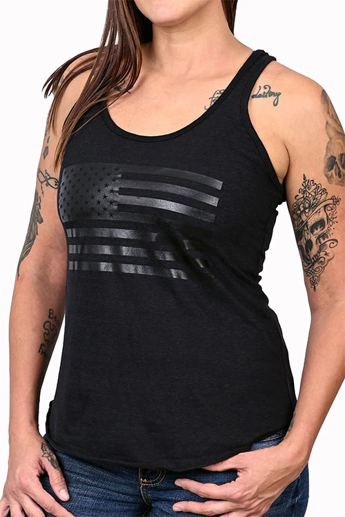 Woman wearing black tank top with shiny, black American flag print on the chest.
