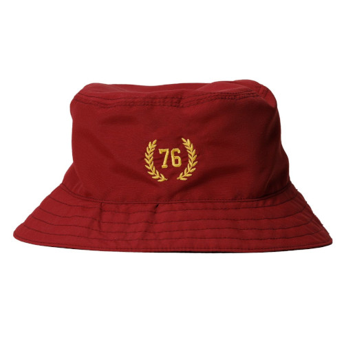 Red nylon bucket hat with golden embroidered emblem on the front. 